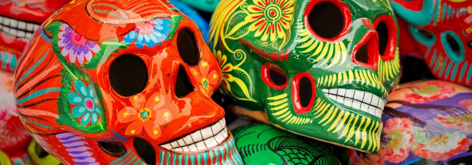 Decorated colorful skulls, ceramics death symbol at market, day of dead, Mexico