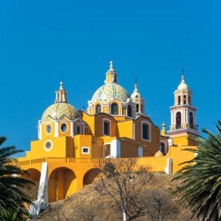 Stunning Our Lady of Remedies church and palm trees in Cholula, Mexico