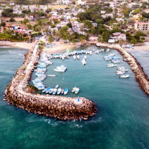 A Drone shot of a little marina full of fishing pongas  in the city of Punta De Mita, Mexico