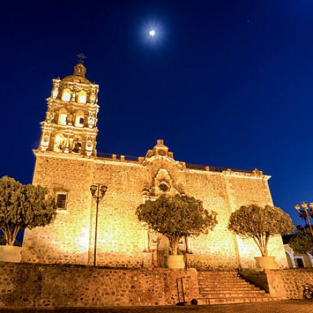 200 year old catholic church in Alamos, Sonora Mexico at night with moon above